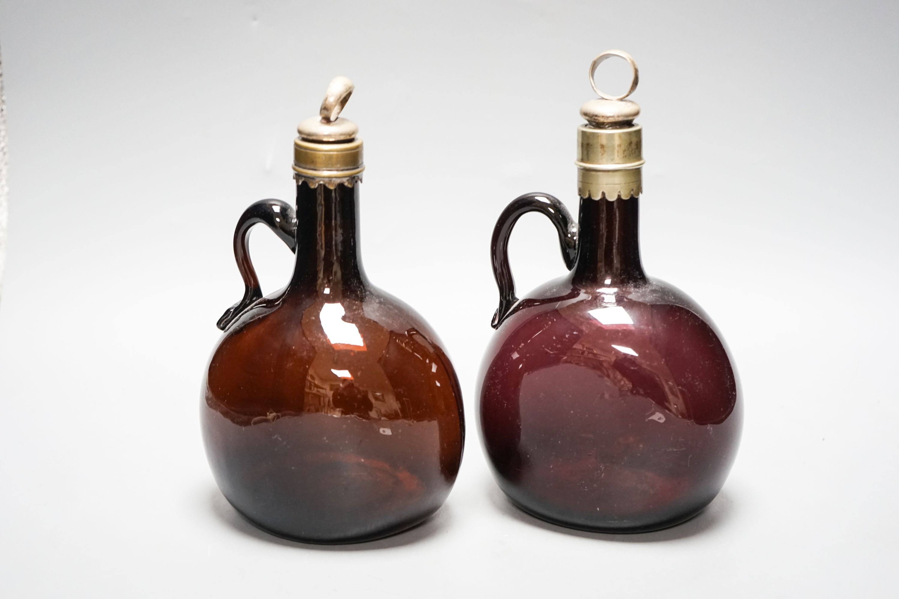 A Victorian amethyst glass claret and amber hock jugs, 23cm